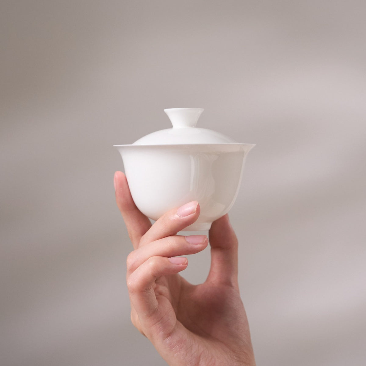 Eggshell Bone China Gaiwan held in hand for scale
