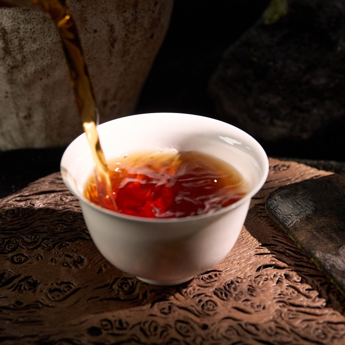 Pouring brewed Shui Xian Wuyi Rock Tea during tea service