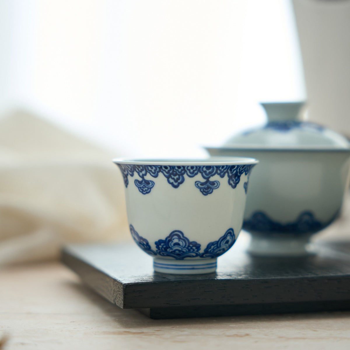 Baoxiang Floral Blue-and-White Porcelain Tea Cup in a styled gongfu tea setting