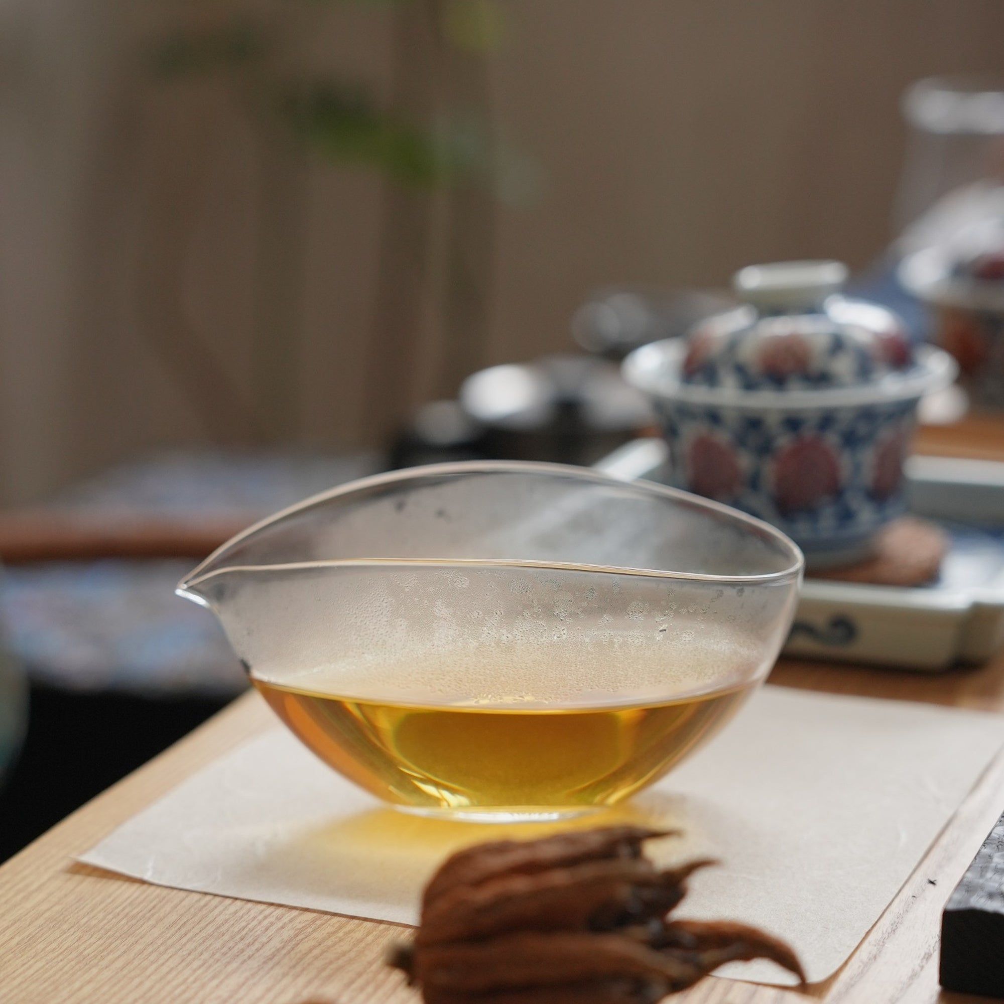Leaf Boat Glass Fairness Pitcher filled with tea in a gongfu tea setting