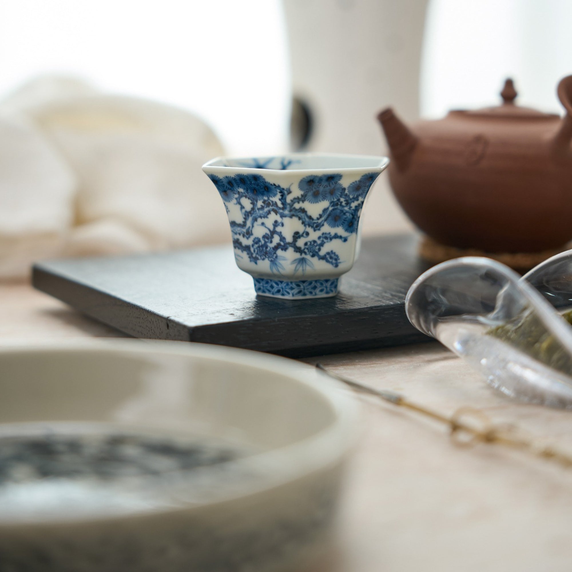 Three Friends of Winter Hand-Painted Octagonal Tasting Cup in a styled gongfu tea setting