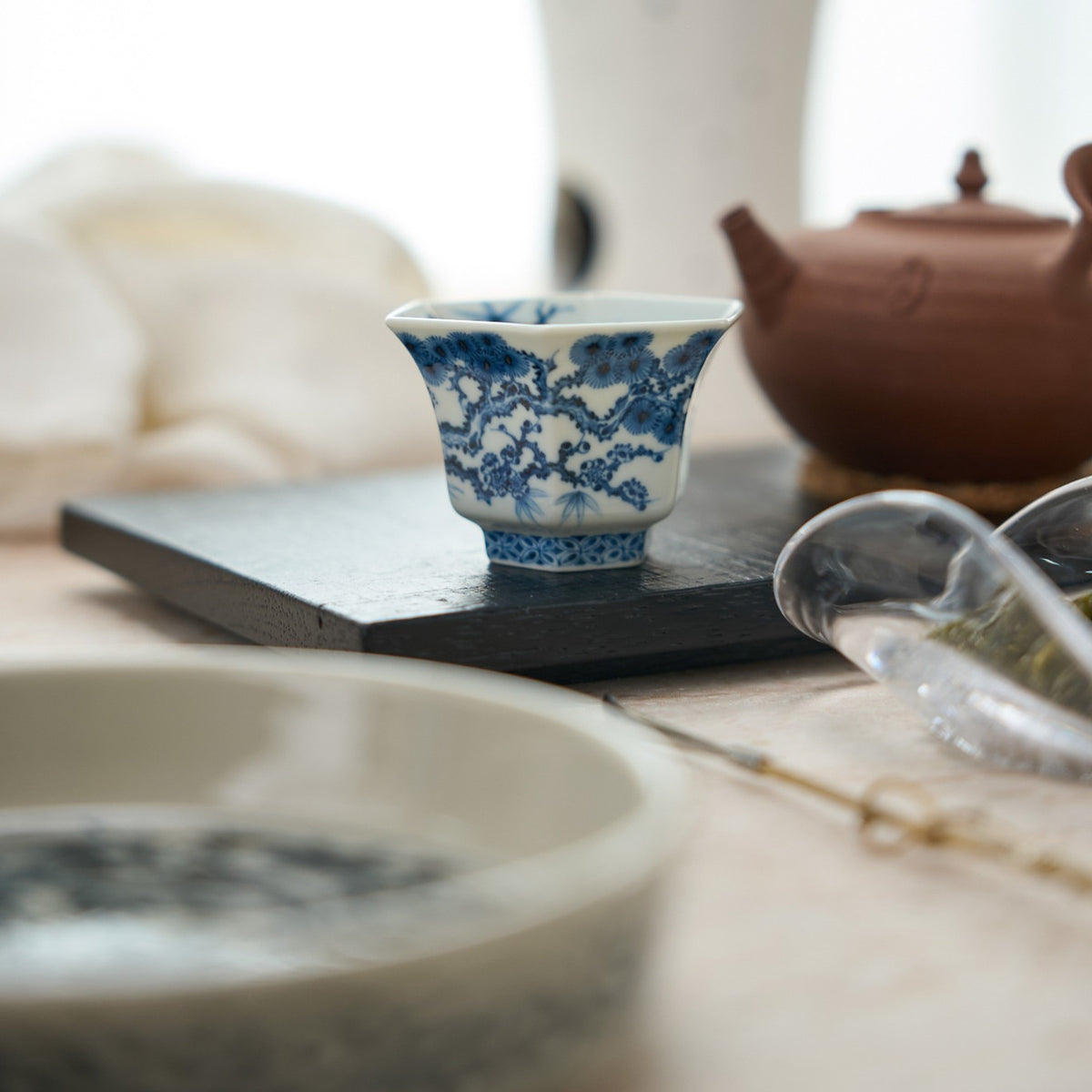 Three Friends of Winter Hand-Painted Octagonal Tasting Cup in a styled gongfu tea setting