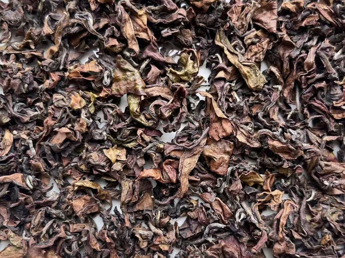 Tea leaves spread across a white tray