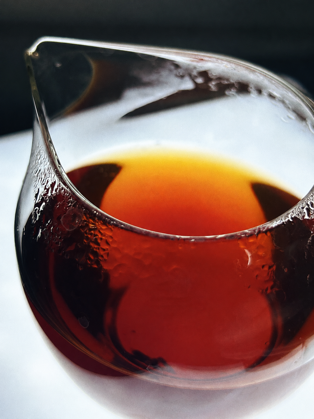Reddish amber tea in a clear glass pitcher