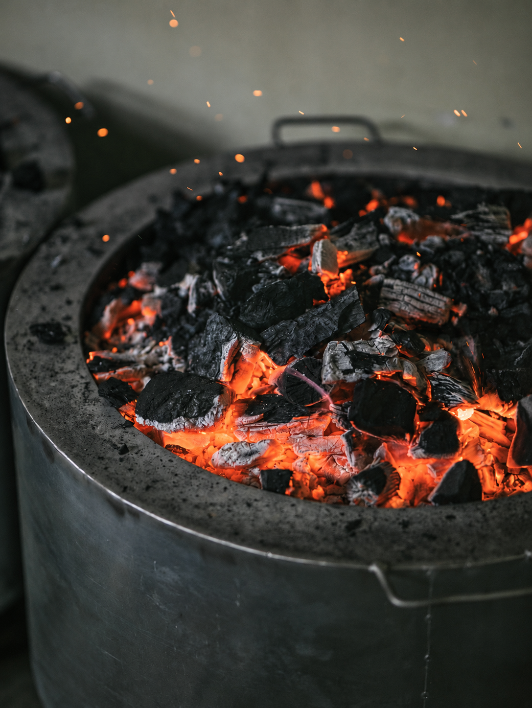 Glowing coals and sparks in a metal container
