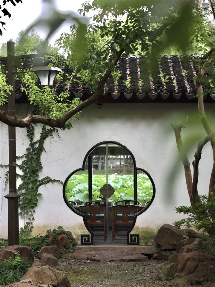 A garden doorway with a tea setting visible inside.